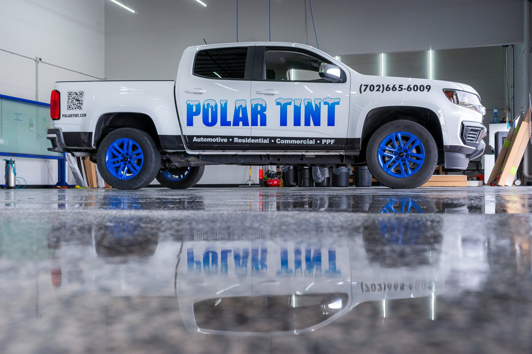 Branded Polar Tint service truck reflected on the shop floor